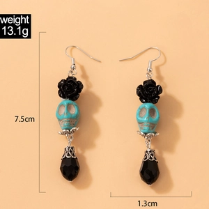 Détail de boucles d'oreilles tête de mort avec roses noires et mesures de 13,1 g
