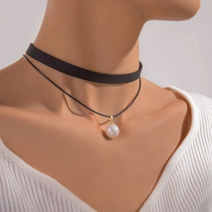 Elegant double-layered black choker necklace featuring a white pearl and gold clasp detail
