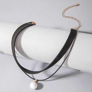 Close-up of double-layer choker with black velvet band and white pearl pendant detail
