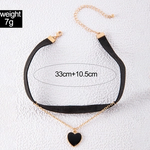 Detail view of double-layer choker with black velvet, gold chain, and heart pendant