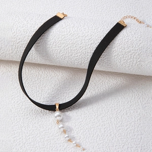 Detail of black velvet choker featuring five graduated pearls and golden clasp hardware
