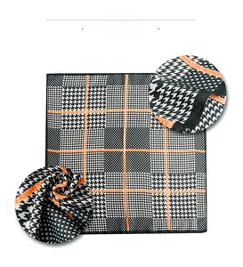 Detail show of black houndstooth silk scarf with orange Fashion Modern text border