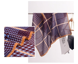 Detail of navy and burgundy houndstooth silk scarf featuring modern fashion lettering