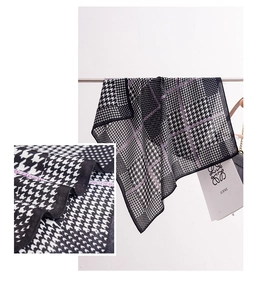 Detail shot of black and white houndstooth scarf with elegant purple fashion borders