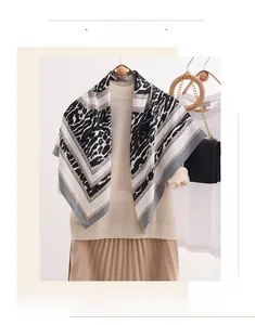 Classic leopard print silk scarf paired with a chic chain bag and beige pleated skirt