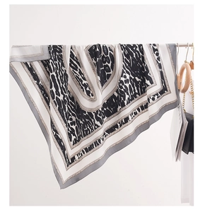 Detailed view of large leopard print silk scarf with grey stripes and rope edge design