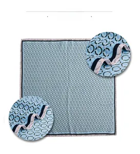 Detailed macro view showing the woven texture and chain patterns of light blue silk scarf