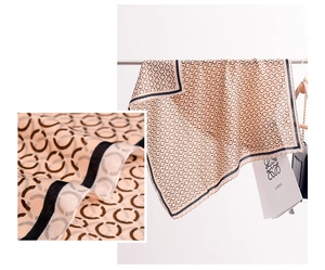 Macro detail of silk-like beige scarf showing twill texture and geometric pattern