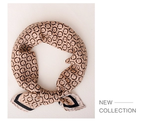 Detail showing the soft drape of a silk scarf with luxury geometric patterns