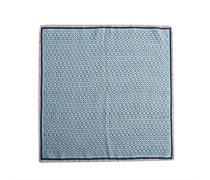 Detail of square silk scarf with sky blue geometric pattern and beige wave border