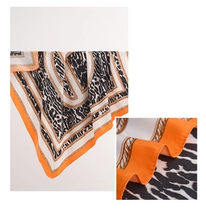Detail of leopard print silk scarf featuring premium texture and orange rolled edges