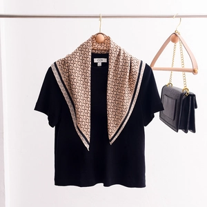 Chic beige and black chain geometric print silk square scarf on elegant wooden hanger