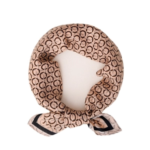 Elegant silk scarf featuring brown chain prints and black borders on light coffee fabric