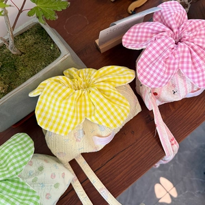 Macro view of seersucker cotton drawstring bags with cute bear patterns and floral tops