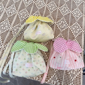 Three cute drawstring bucket bags with cartoon patterns and ruffled floral trim