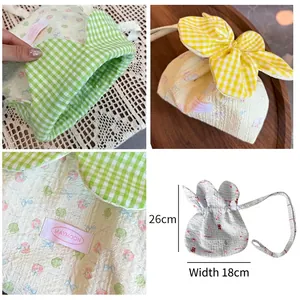 Sweet floral drawstring bag with plaid lining and textured cherry pattern for commuting