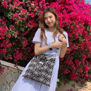 Floral embroidery black tote bag with white daisy patterns and lace trim detail