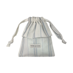 Blue and white striped drawstring bag with floral lace trim and You're So Cute label