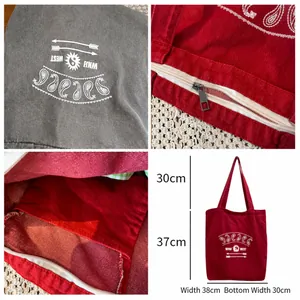 Red washed canvas tote bag with paisley print, zipper closure and interior pocket details