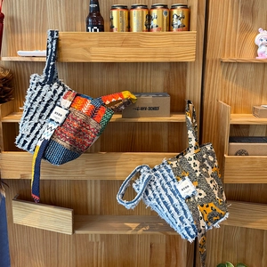 Detail of bohemian patchwork denim handbags with frayed edges and ethnic patterns