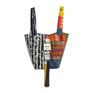 Bohemian patchwork denim tote bag with colorful ethnic patterns and fringe detail