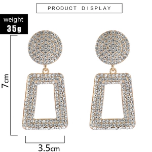 Close-up of geometric hollow drop earrings with full diamond pavé and 7cm height scale
