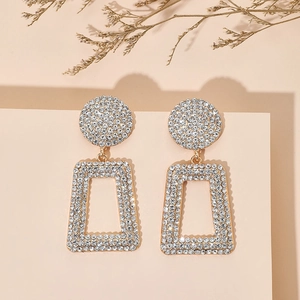 Detail of luxury gold geometric hollow earrings with sparkling pavé rhinestones
