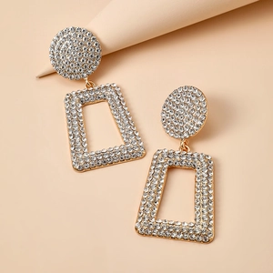 Detail of gold geometric hollow earrings with micro-pave white rhinestones settings