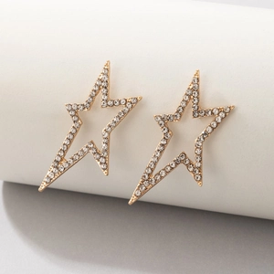 Macro shot of gold geometric star stud earrings encrusted with sparkling white zircons