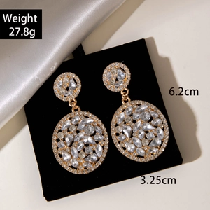 Detail view of large gold-tone drop earrings with pave rhinestones and measurements