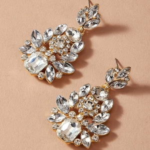 Macro shot of gold-plated cluster statement earrings with radiant teardrop rhinestones