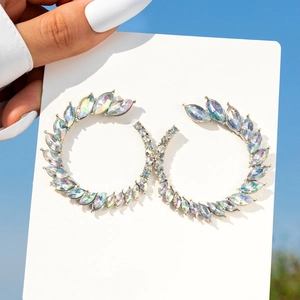 Close-up of oversized C-shaped earrings with marquise-cut aurora borealis crystals