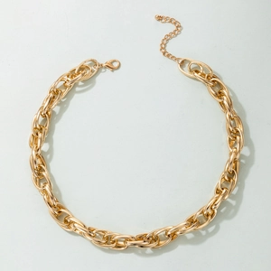 Detail of chunky gold chain link necklace with lobster clasp and adjustable extension chain