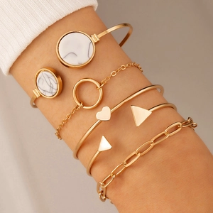 Detailed view of six-piece gold geometric bracelet set with heart and marble accents