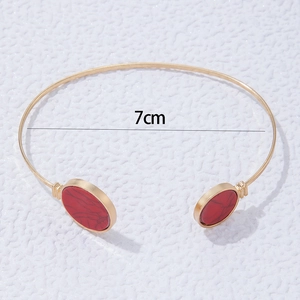Detailed view of gold bangle with red stone inlay and 7cm inner diameter measurement