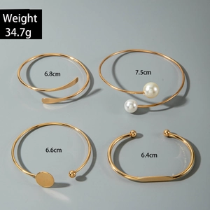 Detail view of 4-piece gold bangle set with inner diameter and 34.7g weight specs
