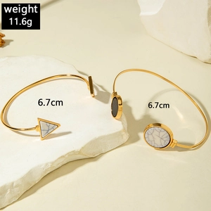 Detail of gold geometric bracelets with marble stone inlays, 6.7cm size and 11.6g weight