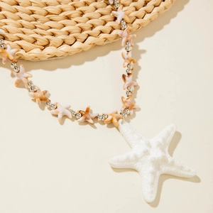 Detail of bohemian starfish necklace featuring white resin star pendant and silver beads