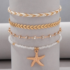 Detalle de set de 4 tobilleras multicapa con dije de estrella de mar y cuentas doradas