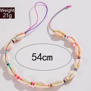 Detail showing natural white shells and colorful beads on a summer beach necklace