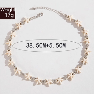 Detail of beaded shell necklace featuring white starfish and silver metal round beads