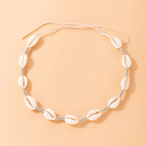 Close-up of shell bead necklace with silver beads and bohemian woven cord detail