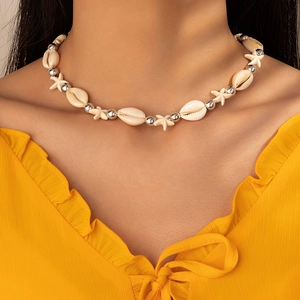 Detail of seashell choker with starfish and silver beads on a bohemian beach necklace