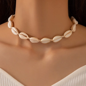 Close-up of handmade cowrie shell choker necklace with natural bohemian beach style vibes