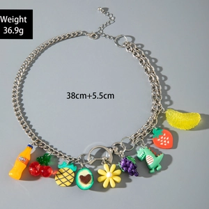 Detail of layered necklace featuring colorful resin fruit charms and a soda bottle pendant