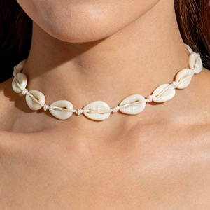 Close-up of bohemian shell choker necklace featuring white shells on woven cord