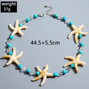 Detail of beach theme necklace with starfish charms and blue beads on grey background