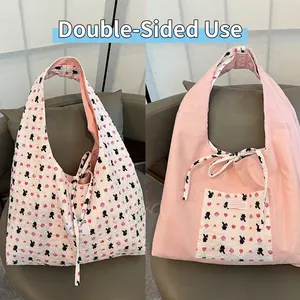 Detailed comparison of reversible tote bag with bear pattern and pink solid side