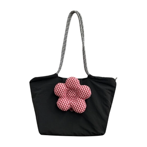 Black canvas lunch tote bag with large red checkered flower and braided shoulder straps