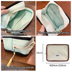 Portable travel cosmetic bag with partitions and Hope label on wood background